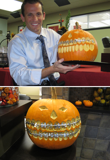 Dr. Pellegrini shows off his pumpkin carving skills